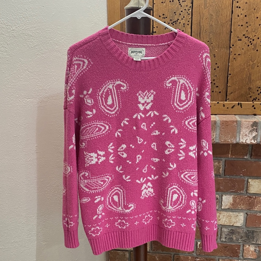 This item is an American Eagle Pink Bandana Paisley Pullover Sweater